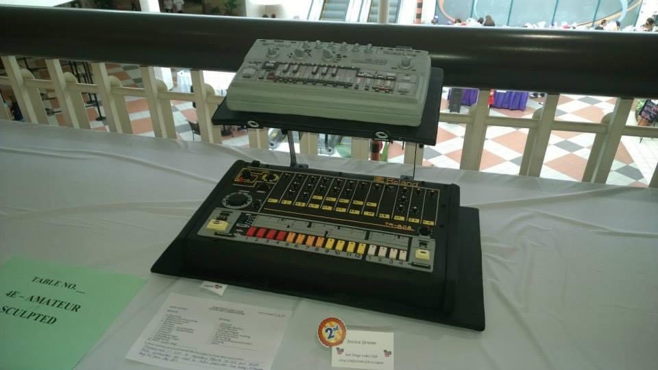 Roland TR-808 and TB-303 cakes on display at the San Diego Cake Club with a 2nd place ribbon