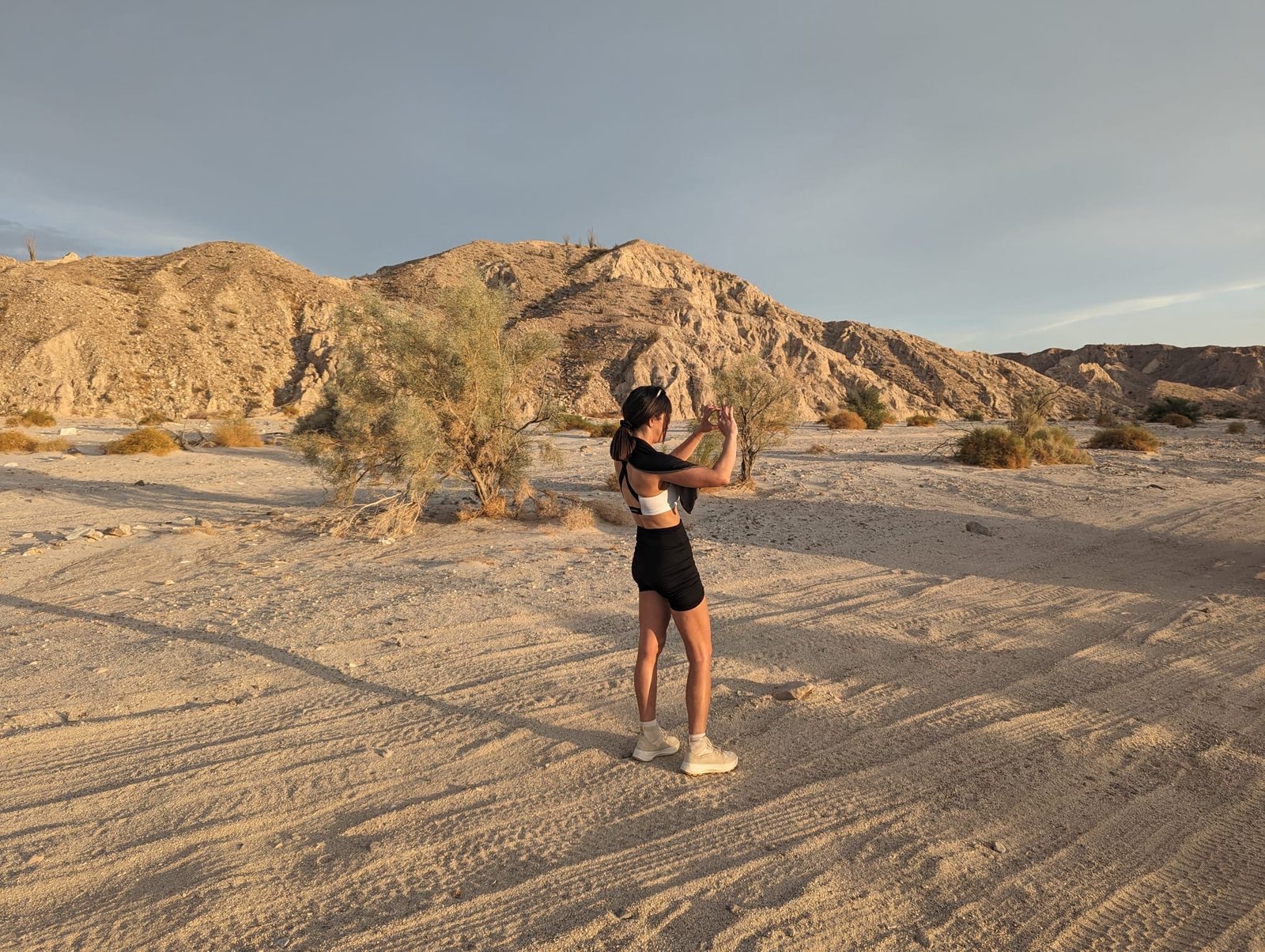 Jessica in the Anza-Borrego desert at golden hour, photographing the badlands