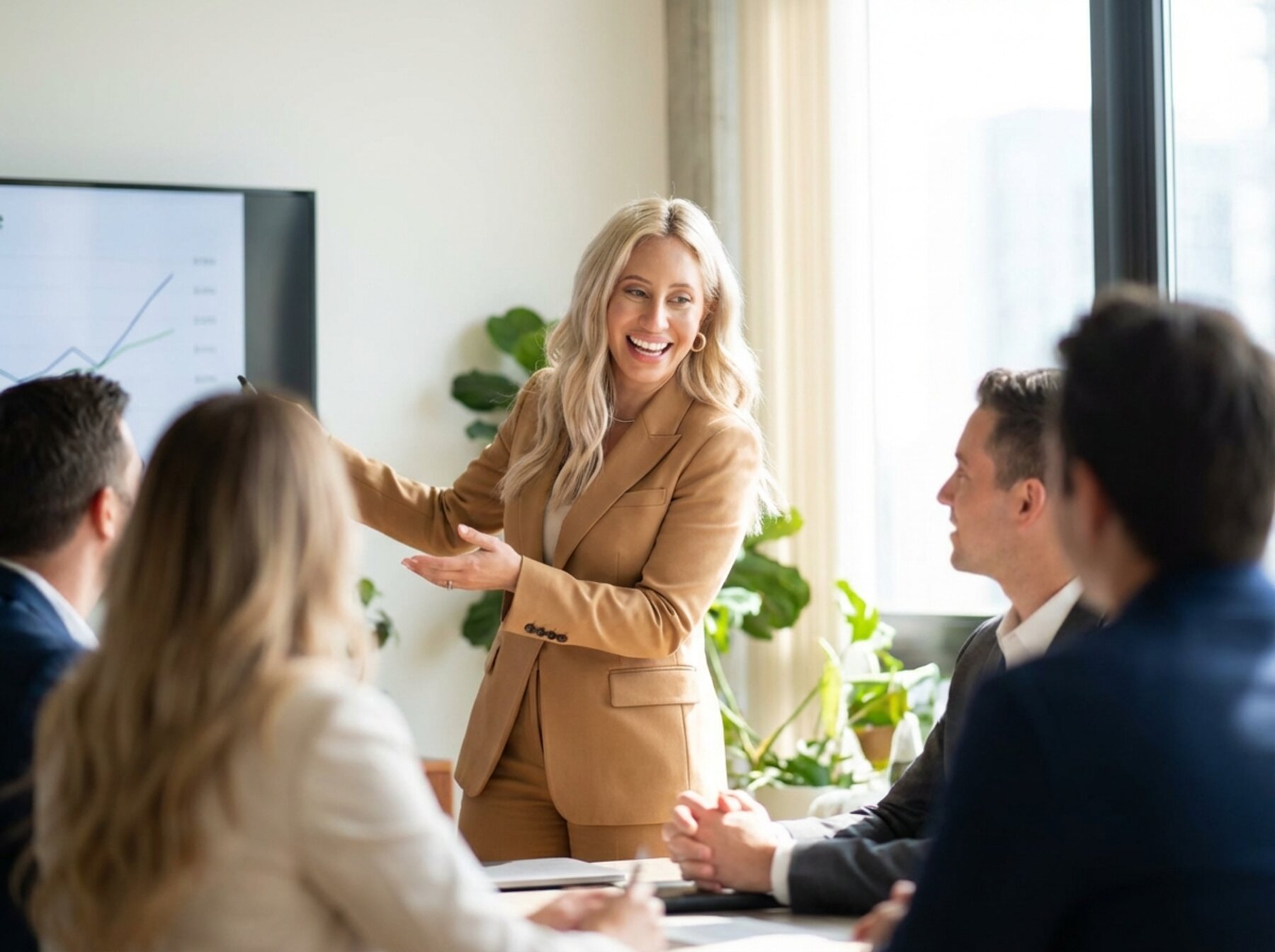Jessica presenting to a customer team in a boardroom, mid-conversation