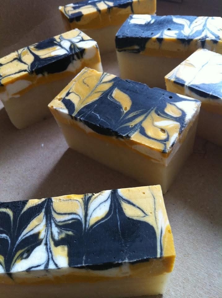 Handmade cold-process soap with yellow, black, and white swirls